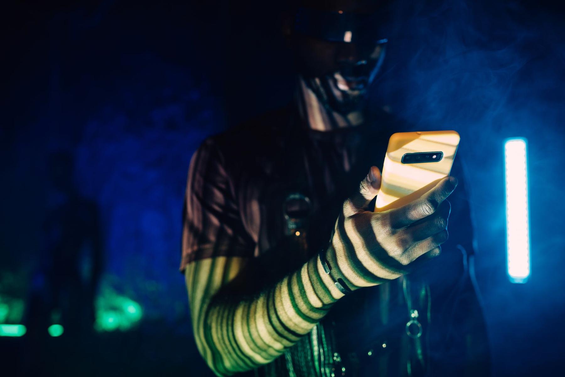 A phone glowing in neon light
